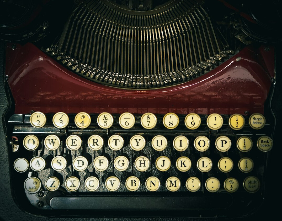 writer typing on old typewriter