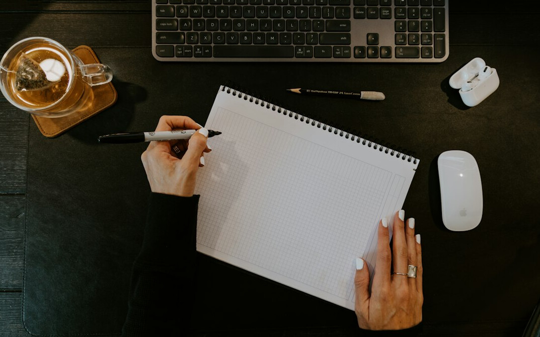 mystery writer at desk with real events notes